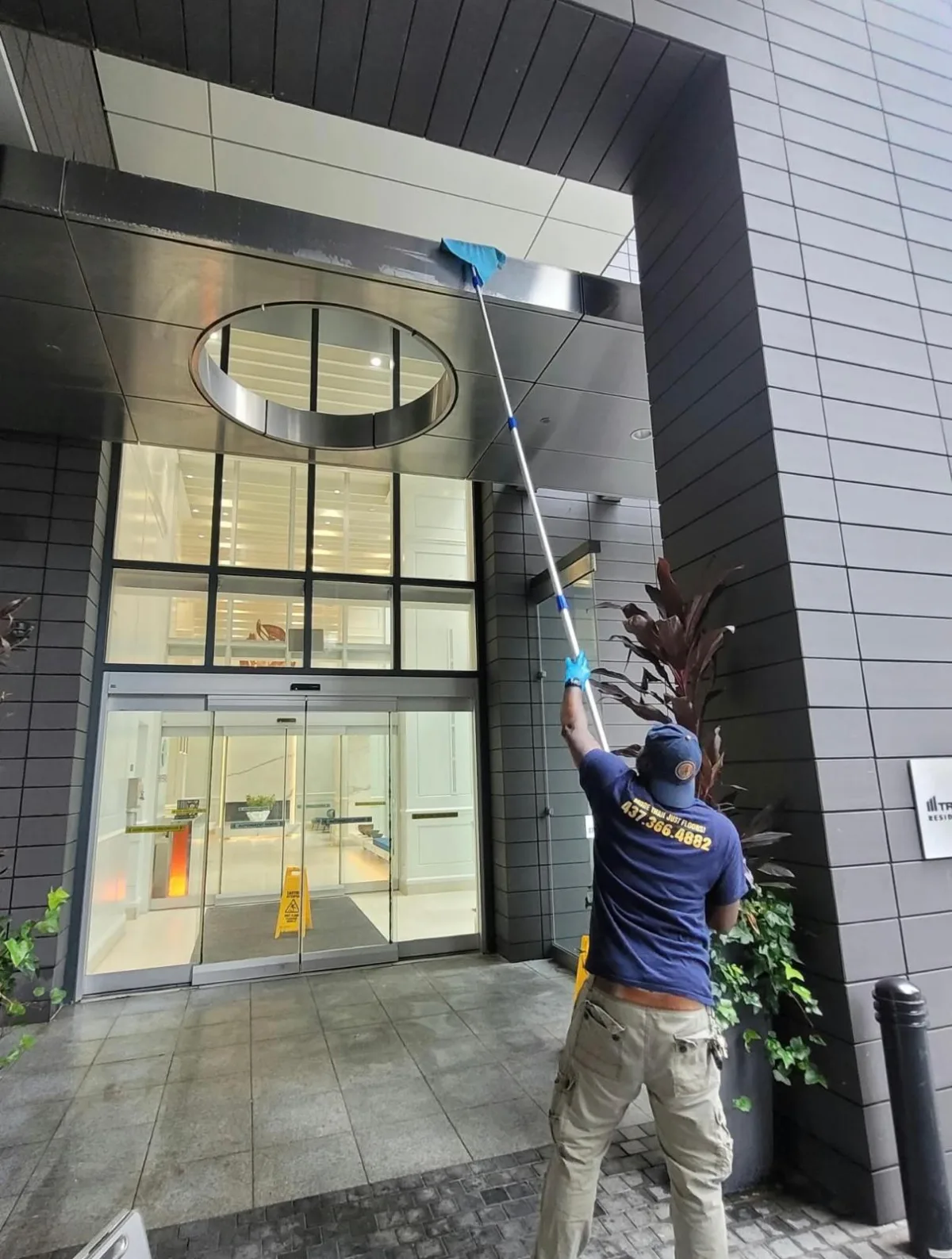 AAFM technician cleaning a commercial building entrance canopy